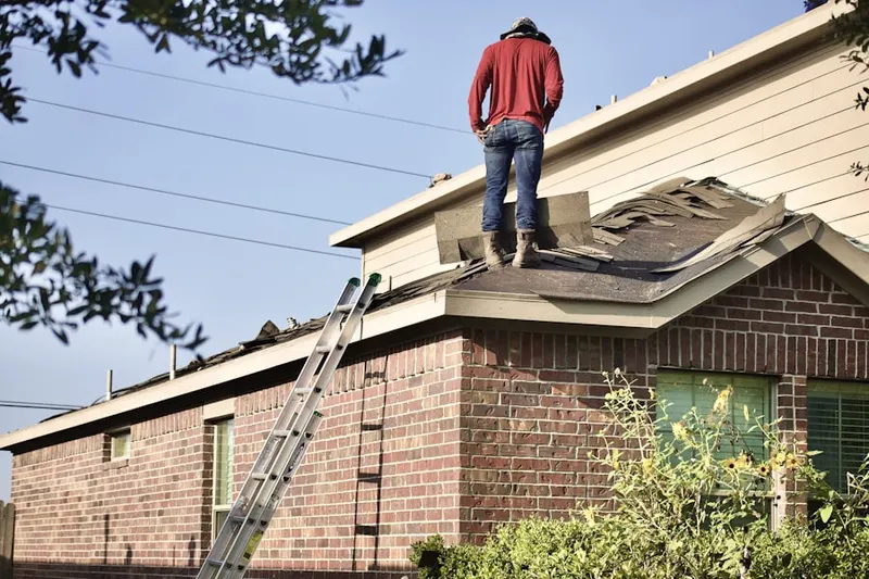 Professional roofer working on a residential roof in Naceville